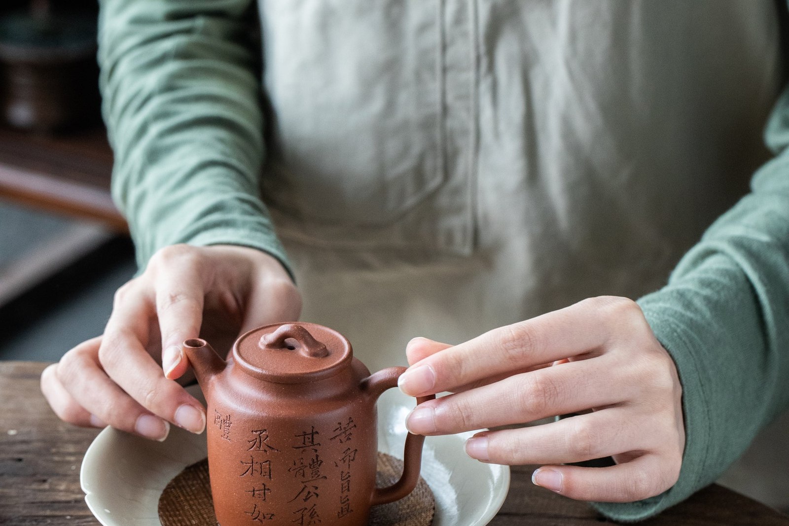 Placing Ceramic Teapot Within White Bowl