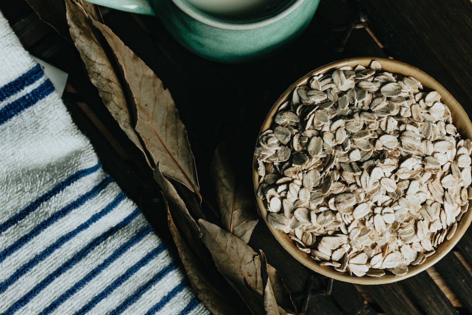 Flatlay Of A Bowl Of Oats Tea And A Towel