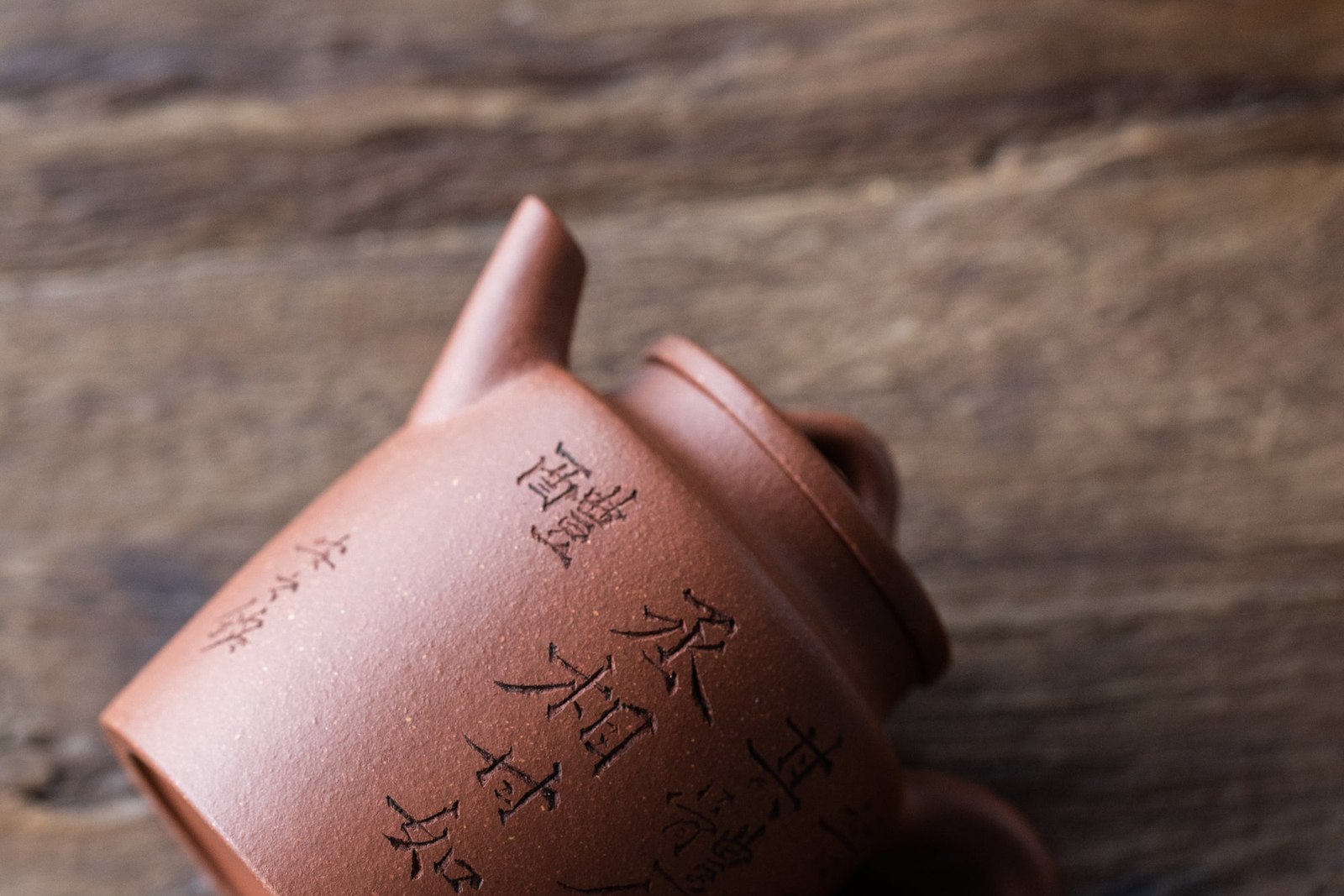 Chinese Teapot On It's Side On Wooden Table